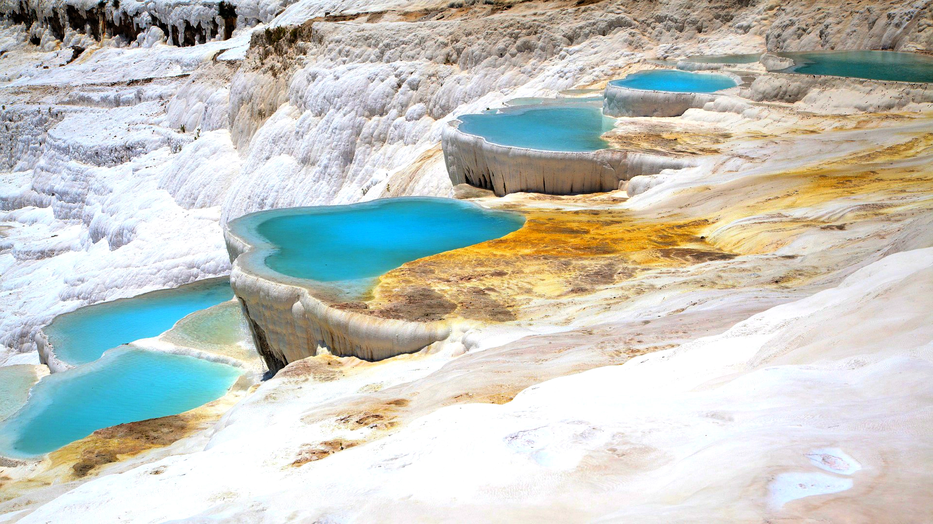 Serene blue pools dotting the rugged mountain terrain.