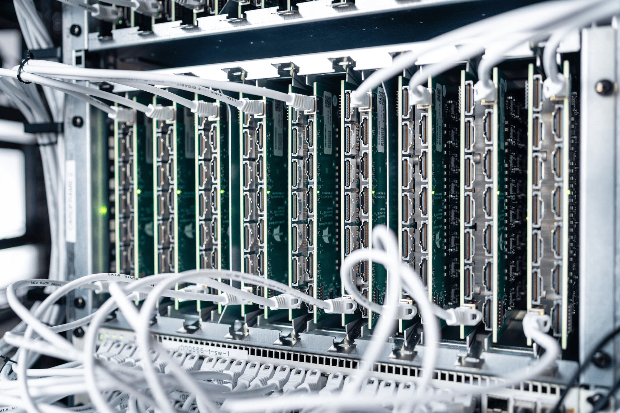 Close-up image of a server rack, featuring a tangle of wires and cables, illustrating the infrastructure of a data center