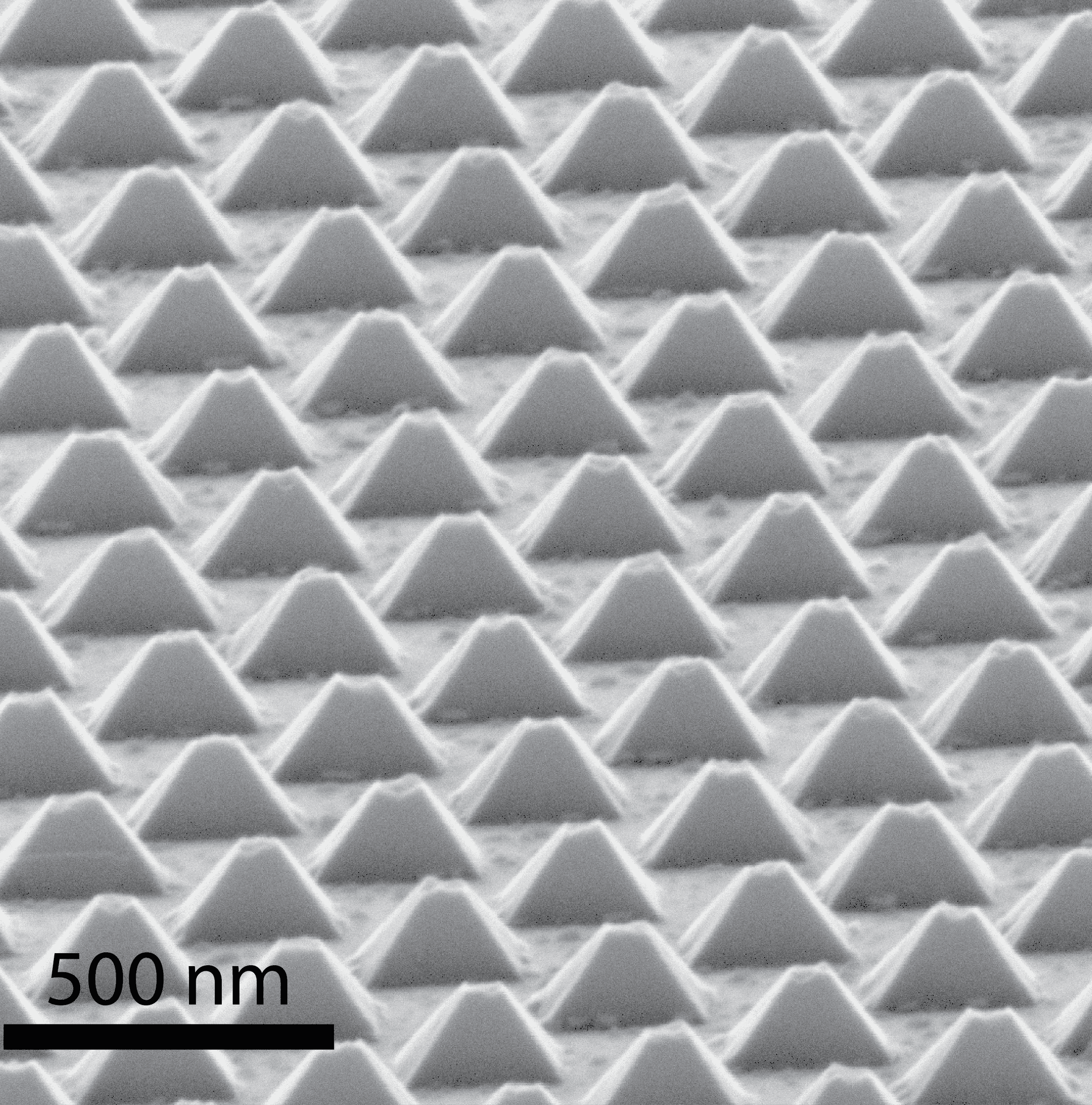 Tilted view SEM image of zinc phosphide nanopyramids grown in a hexagonal array by Simon Escobar Steinvall (included with scalebar).